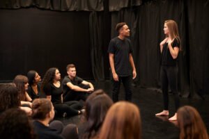 Male And Female Drama Students At Performing Arts School In Studio Improvisation Class